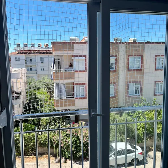 Pencere ve balkon kapısına uygulanmış çocuk güvenlik filesi
